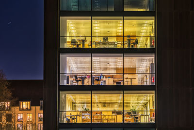 Reflection of building on glass window at night