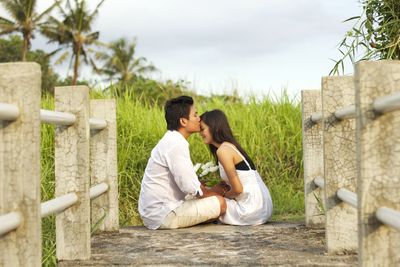 Side view of couple kissing outdoors