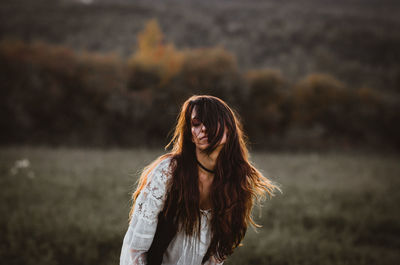 Woman with long hair standing on lake 
