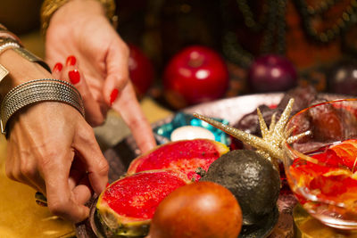 Midsection of woman holding strawberries