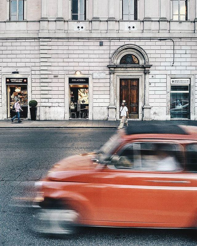 building exterior, architecture, built structure, motion, window, blurred motion, glass - material, street, land vehicle, transportation, car, reflection, mode of transport, transparent, fountain, city, one person, building, long exposure, road