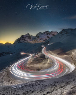 High angle view of light trails on road against sky at night