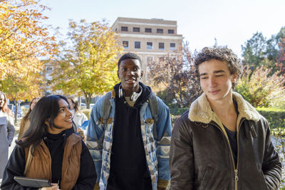 Multiracial friends walking on college campus