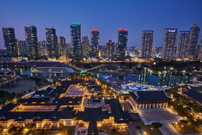 High angle view of illuminated buildings in city at night