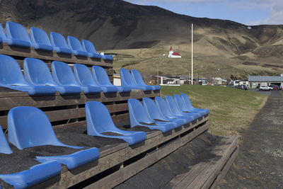 Side view of seats on a tier covered by the lava sands