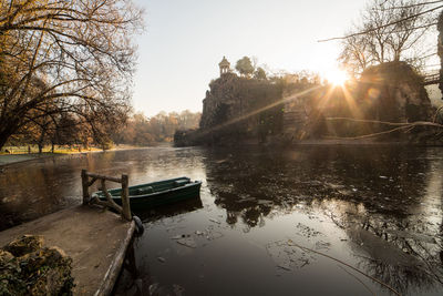 Close-up of fountain against trees during sunset