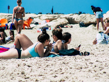 People relaxing on beach
