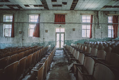 Empty chairs in abandoned building