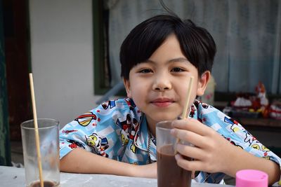 Portrait of boy having chocolate drink at home