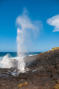 Waterhole with stream of water up in the air. nature background. kiama, australia