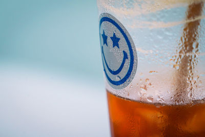 Close-up of beer against blue background