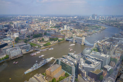 High angle view of river amidst buildings in city against sky