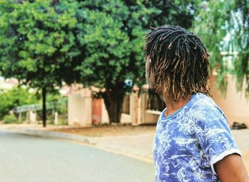 Man standing on road in city