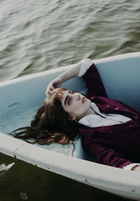 Portrait of woman lying in boat