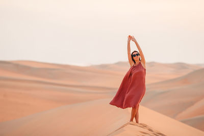 Woman standing in a desert