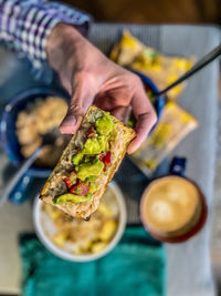 Cropped hand of person holding food