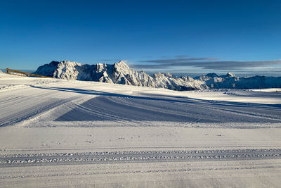 Scenic view of snowcapped mountains against clear blue sky