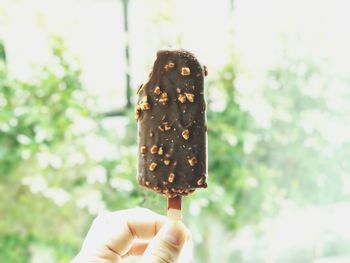 Close-up of hand holding ice cream cone