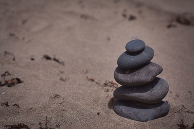 Close-up of stack of pebbles on sand