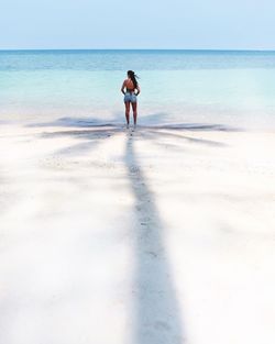 Full length of young woman on beach