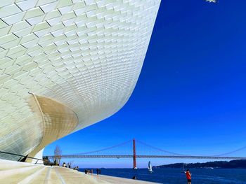 Low angle view of bridge against blue sky