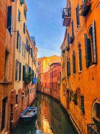 Boat in the canel between houses in venice, italy