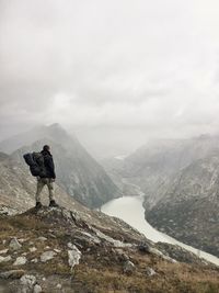 Man alone on a rock with nice view on  grimselpass