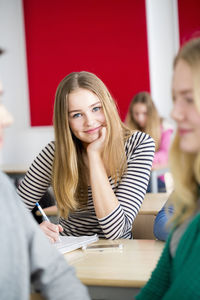 Portrait of teenage girl looking at camera in classroom
