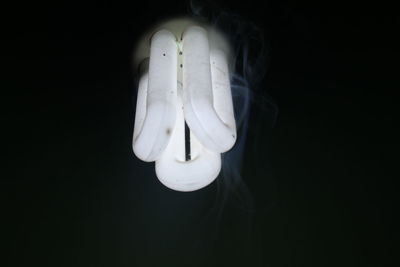 Close-up of light bulb against black background