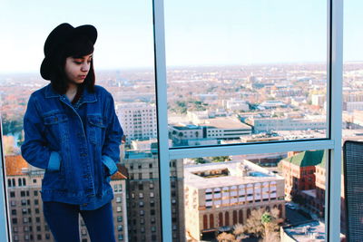 Portrait of a young woman standing in city