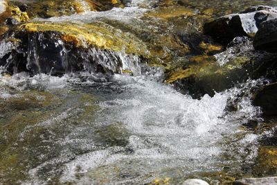 Scenic view of river flowing through rocks