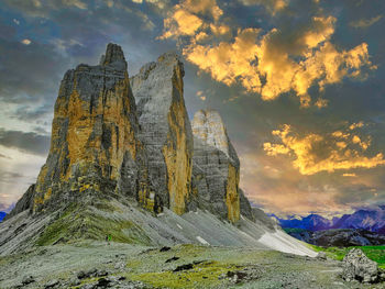 Panoramic view of rocky mountains against sky during sunset