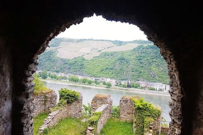 Scenic view of mountain seen through arch