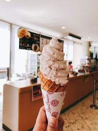 Close-up of hand holding ice cream cone