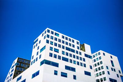 Low angle view of buildings against clear blue sky