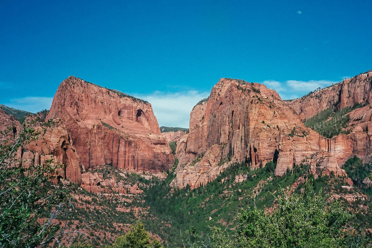 mountain, blue, tranquility, tranquil scene, rock formation, landscape, scenics, beauty in nature, nature, sky, geology, non-urban scene, rock - object, physical geography, rocky mountains, mountain range, remote, grass, rock, idyllic, day, plant, eroded, outdoors, no people, rocky, non urban scene, hill, majestic, travel destinations, cloud