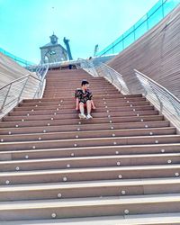 Rear view of people walking on steps