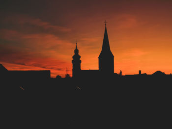 Silhouette of building against sky during sunset