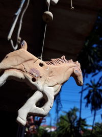 Low angle view of statue hanging