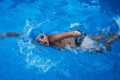 Portrait of paralympic young swimmer crawling in a pool