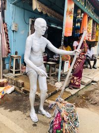 Man working against statue