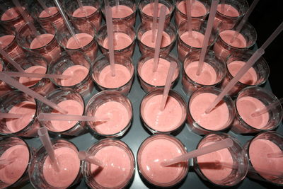 High angle view of smoothies with straw on tray