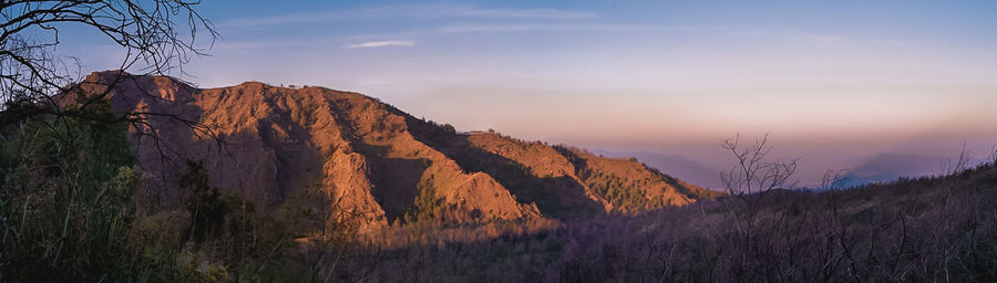 Scenic view of mountains against sky during sunset