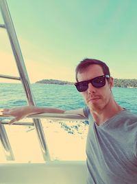 Portrait of young man in boat sailing on sea