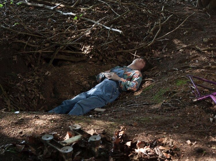 WOMAN LYING DOWN ON GROUND