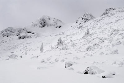 Scenic view of snow covered mountains against sky