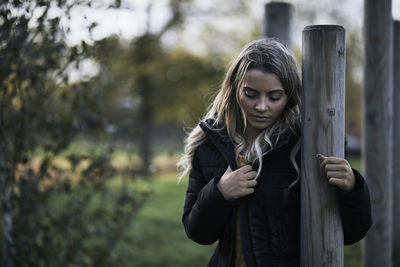 Portrait of beautiful young woman standing in garden