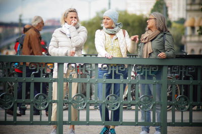 People standing against railing