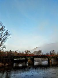 Bridge over lake against sky