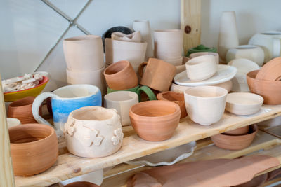 Pottery plates and bowls drying out waiting to be glazed